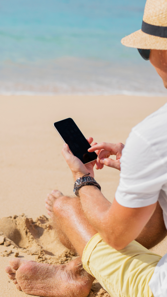 Sunshine Coast business owner using mobile phone for VoIP system so he can work from the beach